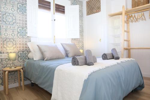 a bedroom with a bed with two pillows on it at APARTAMENTO GRANADA CENTRO in Granada
