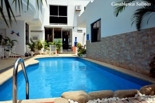a swimming pool in front of a house at Hotel Casablanca Salinas in Salinas