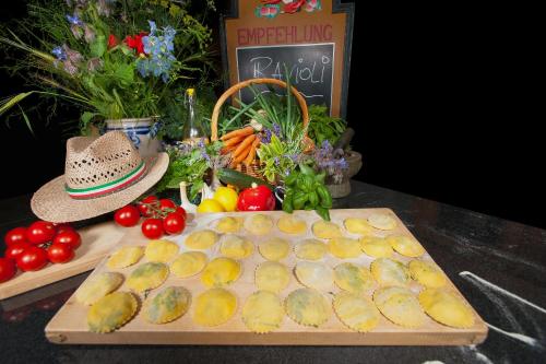 a cutting board with fruit and vegetables on a table at Auberge L'Art in Erfurt