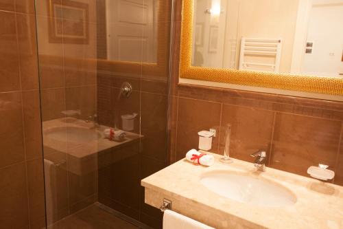 a bathroom with a sink and a mirror at Martins Residence de Luxe in Ravenna
