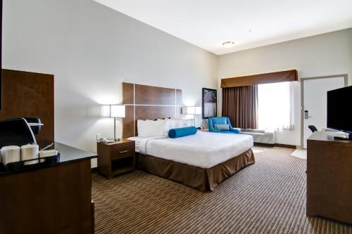 a hotel room with a bed and a television at Canalta Selkirk in Selkirk