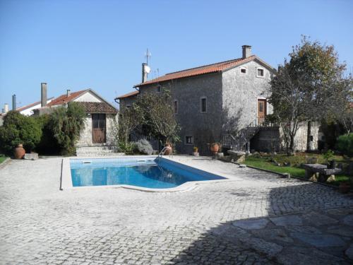 a house with a swimming pool in front of a building at Casa Vale Florido in Alvorge