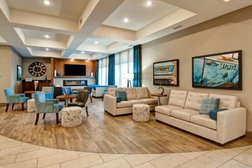 a large living room with couches and chairs at Canalta Selkirk in Selkirk