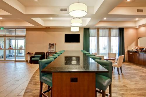 a conference room with a table and green chairs at Canalta Selkirk in Selkirk