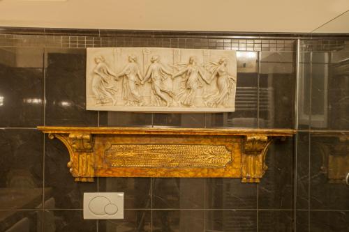 a statue of men on a shelf in a museum at Martins Residence de Luxe in Ravenna