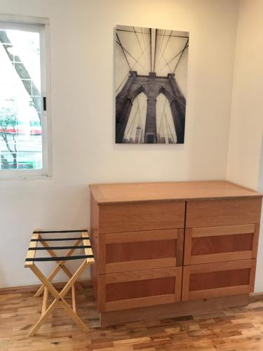 a wooden dresser in a room with a window at The Gallery in Mexico City