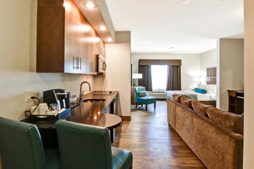 a living room with a kitchen and a living room with a couch at Canalta Selkirk in Selkirk