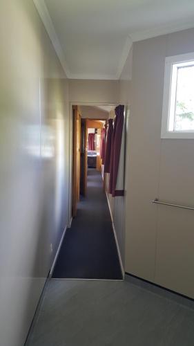 a hallway leading to a room with a window at High Country Lodge, Motels & Backpackers in Twizel