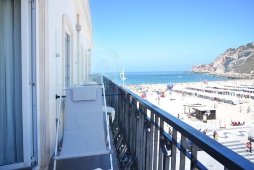 a balcony of a building with a view of a beach at Hotel Mar Bravo in Nazaré