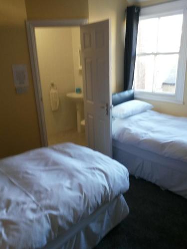 a bedroom with two beds and a window at Spaview in Bridlington