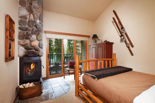 a bedroom with a bed and a fireplace at Moraine Lake Lodge in Lake Louise