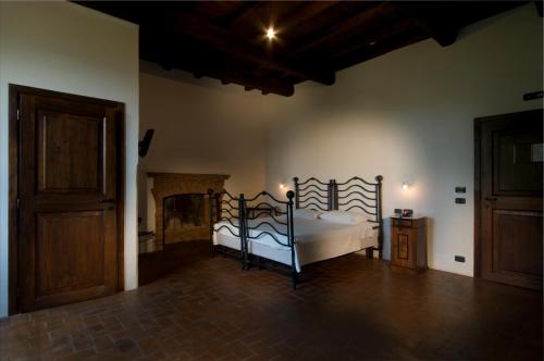 a bedroom with a bed and a wooden floor at Foro Appio Mansio Hotel in Latina