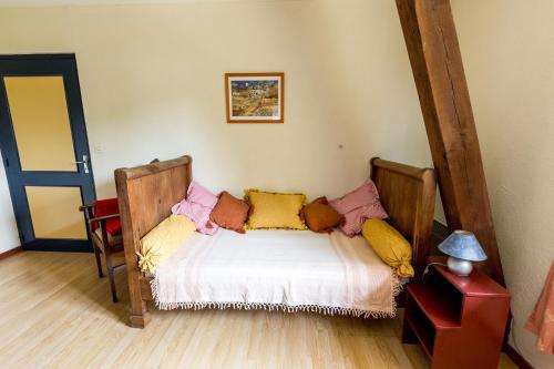 a bedroom with a bed with pillows on it at Chambres d'Hôtes Domaine du Bourg in Gannay-sur-Loire