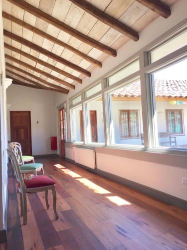 a living room with windows and a wooden floor at Hotel Boutique BC Wine Casablanca in Casablanca
