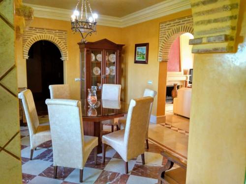 a dining room with a table and chairs at Andalusian experience in Ronda