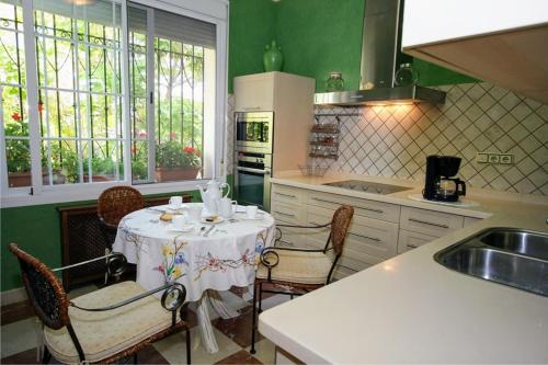 a kitchen with a table and chairs in a kitchen at Andalusian experience in Ronda