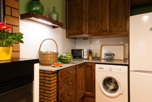 a kitchen with a washing machine and a washer at Ca Felicitat in Vilafames