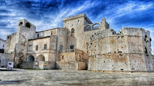 a large stone building with a sky in the background at B&b SAN LORENZO in Conversano