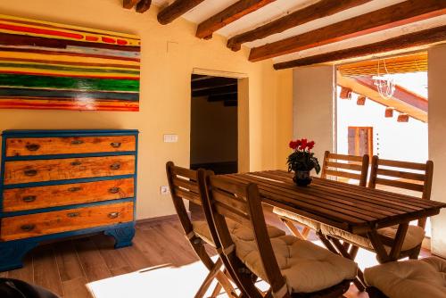 a dining room with a wooden table and a dresser at Ca Felicitat in Vilafames