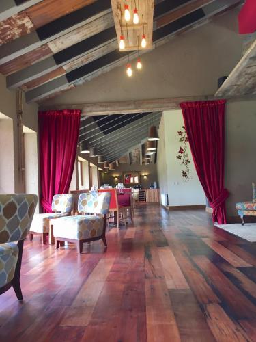a large living room with red curtains and wooden floors at Hotel Boutique BC Wine Casablanca in Casablanca