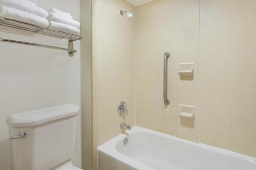 a bathroom with a shower and a toilet and a tub at Baymont by Wyndham Orangeburg North in Orangeburg