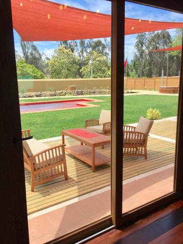 a screened porch with a table and two chairs at Hotel Boutique BC Wine Casablanca in Casablanca
