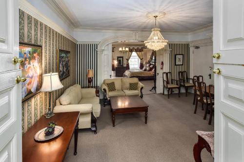 a living room filled with furniture and a large window at The Noble Suites in Brockville