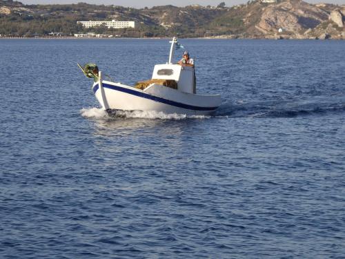 a small boat in a large body of water at Dionysia Studios in Kefalos