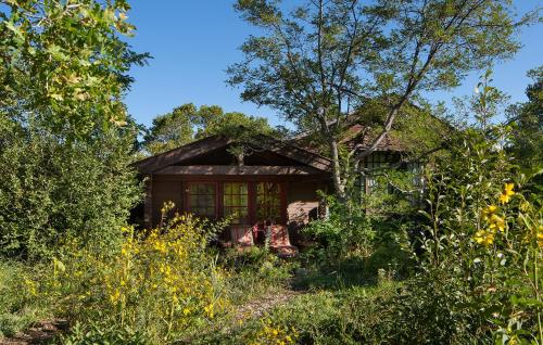 a small house in the middle of a field at Blue Lake Ranch in Hesperus
