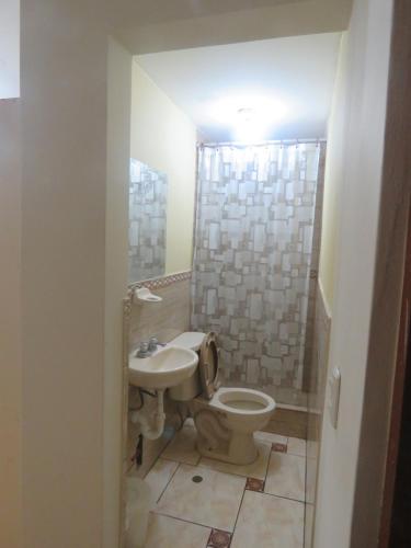 a bathroom with a toilet and a sink at Casa particular de Jorge Edinson in Lima