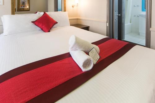 a hotel room with a bed with a towel on it at City Square Motel in Melbourne