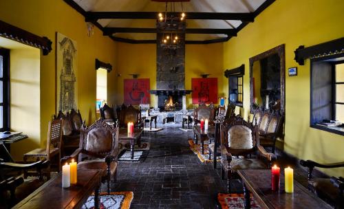 a room with tables and candles and a fireplace at Hotel Hacienda El Salitre in Paipa