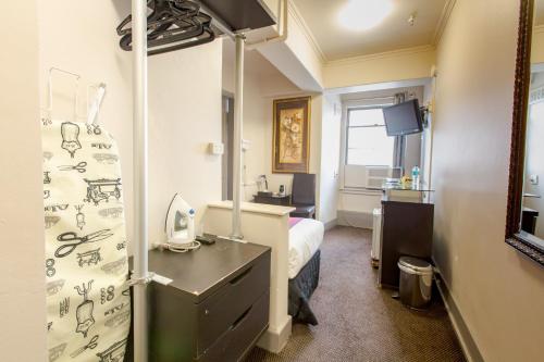 a hospital room with a bed and a sink at City Square Motel in Melbourne