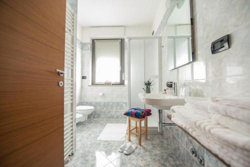 a bathroom with a sink and a toilet at Draconerium Hotel in Dronero