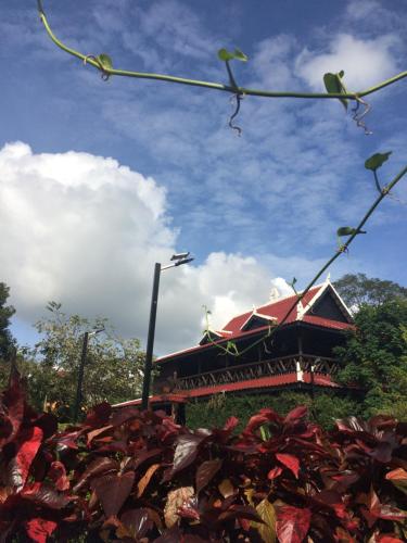 a building with a red roof in front at Greenhouse Retreat in Sen Monorom