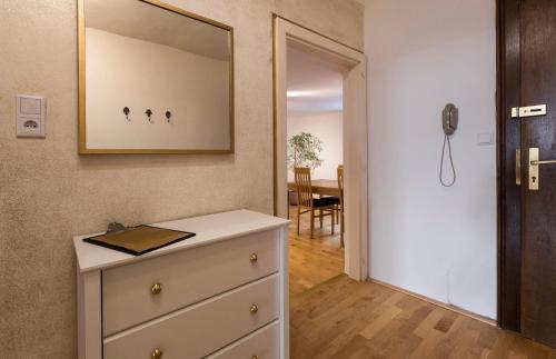 a room with a dresser and a mirror on the wall at Next2Mozart-Apartment in Salzburg