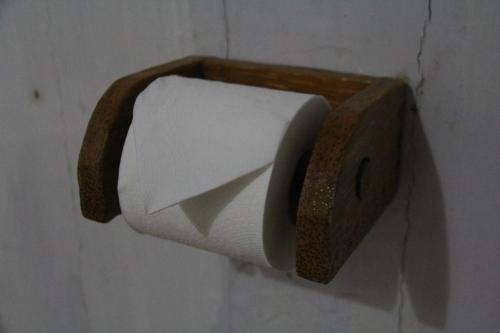 a roll of toilet paper hanging on a wall at Pondok Wisata Pantai Cemara in Mondu