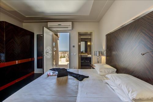 a bedroom with a large bed with a wooden headboard at Hotel Byron in Rimini