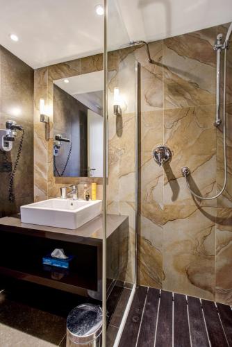 a bathroom with a sink and a shower at Hotel Byron in Rimini