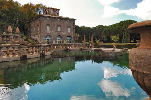 a large building with a pond in front of it at Hotel Ristorante Bagnaia in Viterbo