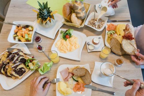 a table with many plates of food on it at R&R Residenzen HOTEL in Mitterbach