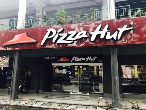 a pizza hut sign on the front of a store at USM Designer Dwell in George Town