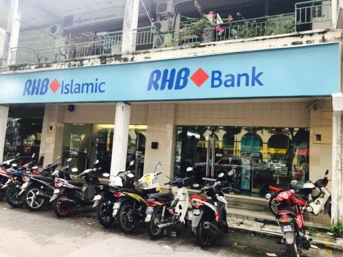 a row of motorcycles parked in front of a bank at USM Designer Dwell in George Town