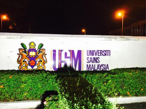 a sign on a wall with graffiti on it at USM Designer Dwell in George Town