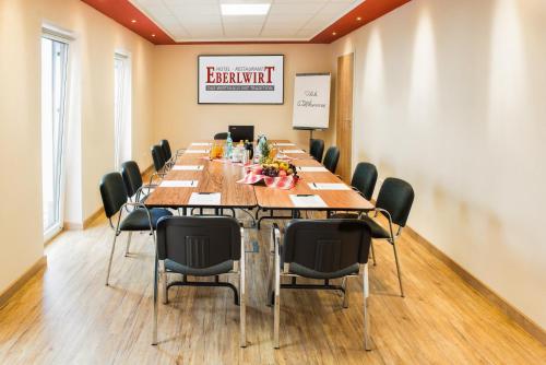 a conference room with a long table and chairs at Hotel - Restaurant Eberlwirt in Bruckberg