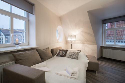 a living room with a couch and a table at Old Riga Dome Square Apartment in Riga