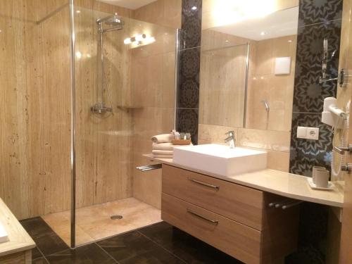a bathroom with a sink and a shower at Haus Alp Deluxe in Längenfeld