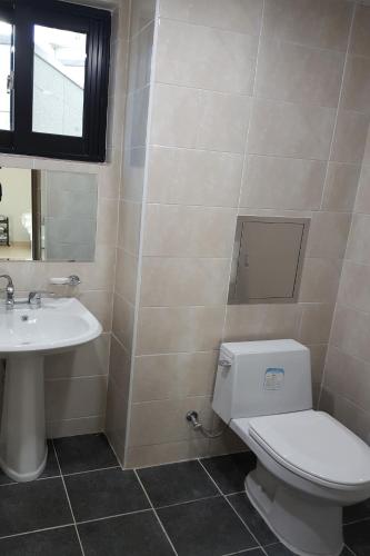 a bathroom with a toilet and a sink at O'guest in Haeundae in Busan