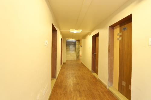 a corridor of an empty hospital hallway at Hotel Loyal Residency in Jamnagar
