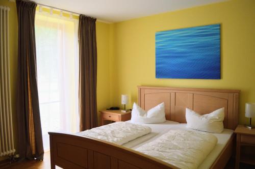 1 dormitorio con 1 cama con una pintura azul en la pared en Ferienpark am Glubigsee, en Wendisch Rietz
